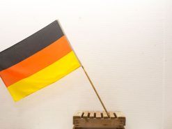 German flag with wooden support, ideal for vintage displays and showcasing national pride.