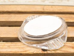 Elegant glass dish with creamy filling on rustic wooden table, inviting and warm presentation.