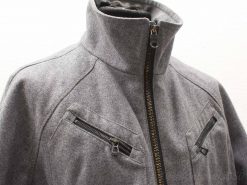 Stylish gray jacket with high collar and angled zippered pockets, versatile for any occasion.