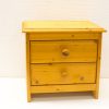 Stylish minimalistic pine bedside table with two functional drawers and warm natural finish.