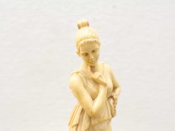 Intricate ivory statue of a thoughtful woman, showcasing serenity and elegance in craftsmanship.