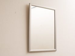 Sleek modern mirror with rounded edges, enhancing minimalist decor and inviting creative reflection.