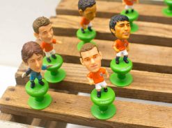 Vibrant orange soccer figurines showcasing unique designs and dynamic poses for collectors and fans.