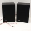 Sleek black compact speakers with minimalist design, perfect for modern audio setups.