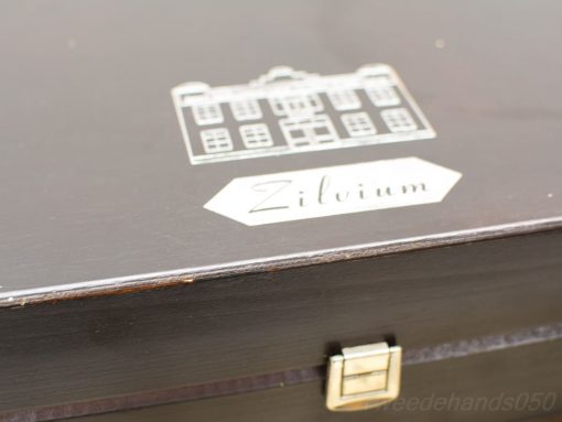 Elegant wooden box with engraved building and Zilvium insignia, perfect for décor and storage.