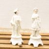 Elegant vintage porcelain couple figurines with intricate details, ideal for collectors and decor.