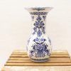 Elegant blue-patterned porcelain vase on wooden surface, perfect for floral displays and decor.