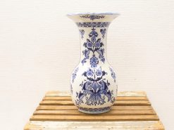 Elegant blue-patterned porcelain vase on wooden surface, perfect for floral displays and decor.