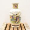 Elegant hand-painted porcelain vase with cultural scenes, adding charm to any collection.