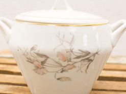 Elegant porcelain sugar bowl with floral pattern and gold accents, perfect for special occasions.