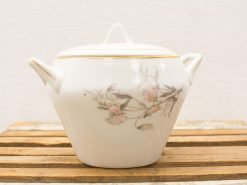 Elegant porcelain teapot with hand-painted floral design and gold trim, perfect for tea gatherings.