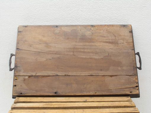 Rustic wooden serving board with handles, perfect for entertaining and adding charm to any table.