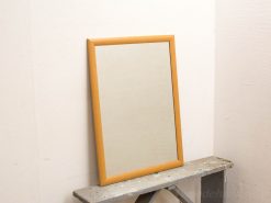 Stylish mirror with light wooden frame, perfect for enhancing modern interiors.