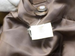 Elegant brown womens coat with button detail and quality care tag for formal occasions.