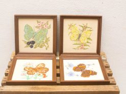 Charming vintage butterfly embroidery collection in wooden frames, perfect for elegant home decor.