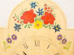 Charming vintage wall clock with floral design and Roman numerals, perfect for nostalgic decor.