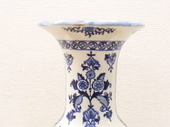 Elegant hand-painted vase in cream and blue with floral designs, perfect for decor.