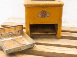 Vintage wooden kitchen apparatus with removable tray, showcasing nostalgic charm and rustic wear.