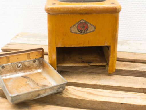 Vintage wooden kitchen apparatus with removable tray, showcasing nostalgic charm and rustic wear.