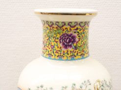 Hand-painted vintage Chinese vase with floral designs and elegant gold accents. Perfect for decor.