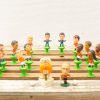 Vintage tabletop football set featuring colorful figurines and a playful mascot for nostalgic fun.