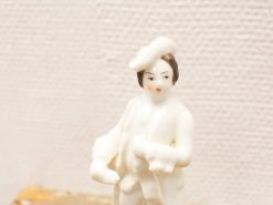 Charming porcelain woman figurine with a dog, embodying elegance and warmth. Perfect for decor.