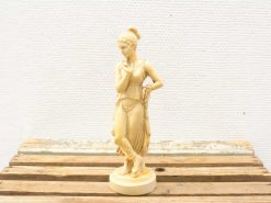 Elegant female statue in classical style with intricate details and serene expression.