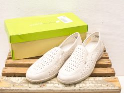 Stylish white perforated shoes in a green box, perfect for casual outings and warm weather.