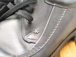 Elegant black leather shoes with JL logo, perfect for any occasion.