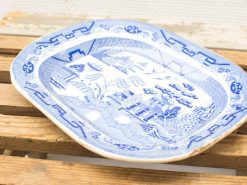 Elegant blue-and-white serving platter featuring intricate landscape design and vintage charm.