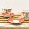 Elegant vintage porcelain cups and saucers with intricate designs for tea or coffee enjoyment.