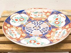 Vibrant ceramic plate featuring floral patterns, showcasing traditional craftsmanship and exquisite artistry.