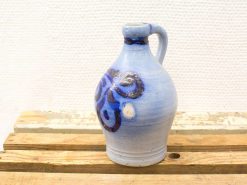 Elegant blue ceramic jug with intricate patterns, perfect for serving or decorative use.