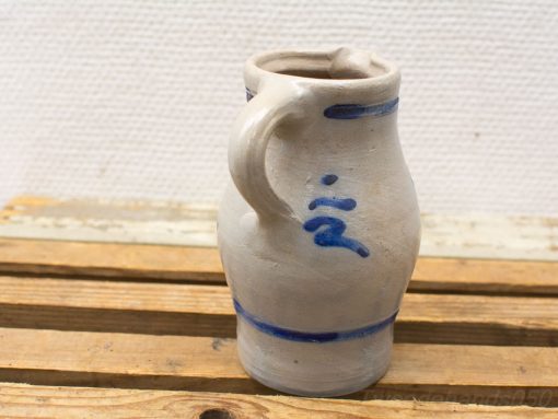 Elegant ceramic jug with blue accents, perfect for everyday use or as decorative display.