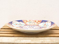 Vibrant ceramic plate with intricate traditional designs, perfect for decoration or serving food.