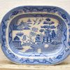 Elegant blue and white porcelain platter featuring a tranquil landscape and traditional architecture.