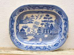 Elegant blue and white porcelain platter featuring a tranquil landscape and traditional architecture.