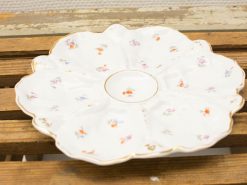 Elegant porcelain plate with floral design and golden rim, perfect for serving or decoration.