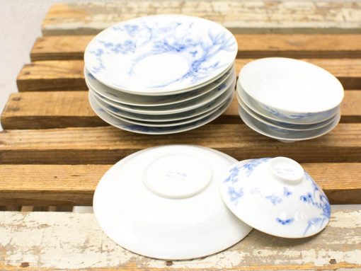 Elegant blue porcelain dish set on rustic wooden table, perfect for any dining occasion.