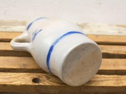 Elegant earthenware jug with blue accents, perfect for rustic decor and practical use.