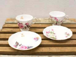 Delicate vintage Royal Vale china cups and plates with floral designs, perfect for tea parties.