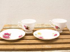 Charming vintage tea cups with floral designs, perfect for afternoon tea or decor.