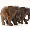 Handcrafted wooden elephant sculptures symbolizing friendship and artistry in dark, polished wood.