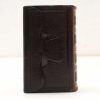 Antique leather book with elegant strap and artisanal design, perfect for secrets or decor.