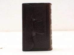 Antique leather book with elegant strap and artisanal design, perfect for secrets or decor.