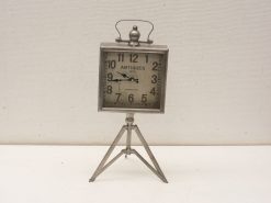 Antique 1870 metal clock with cream face and tripod stand, perfect vintage decor piece.