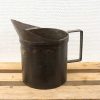 Rustic vintage metal jug with handle and high spout, perfect for decor or practical use.