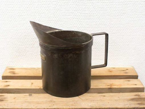 Rustic vintage metal jug with handle and high spout, perfect for decor or practical use.