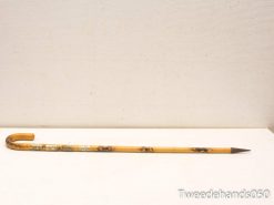 Elegant bamboo cane with decorative metallic elements, perfect for use or as a collectors item.