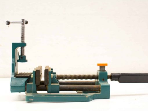 Robust teal hand clamp for woodworking and metalworking projects, featuring adjustable grip and durable construction.